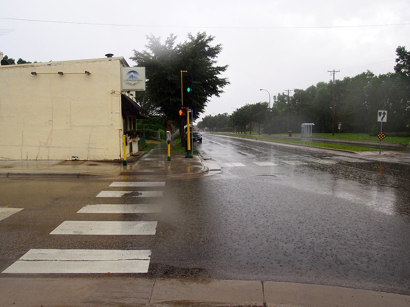 Building on street corner showing stormwater runoff.