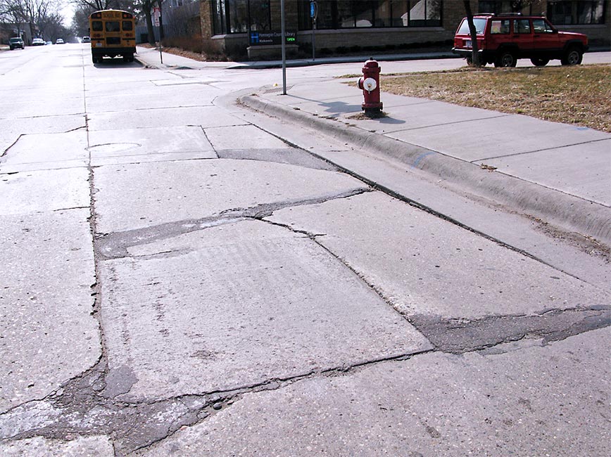 Photo of 34th ave. with cracked pavement before construction Photo of 34th ave. with cracked pavement before construction