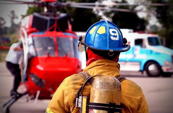 Firefighter watching medical evacuation helicopter