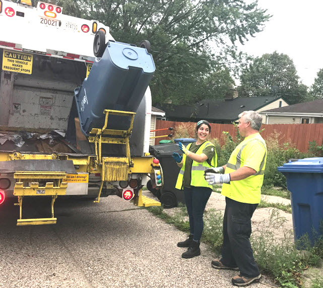 two employees collect recycling