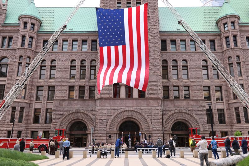 USA flag displayed in front of City Hall by fire trucks during annual police memorial ceremony