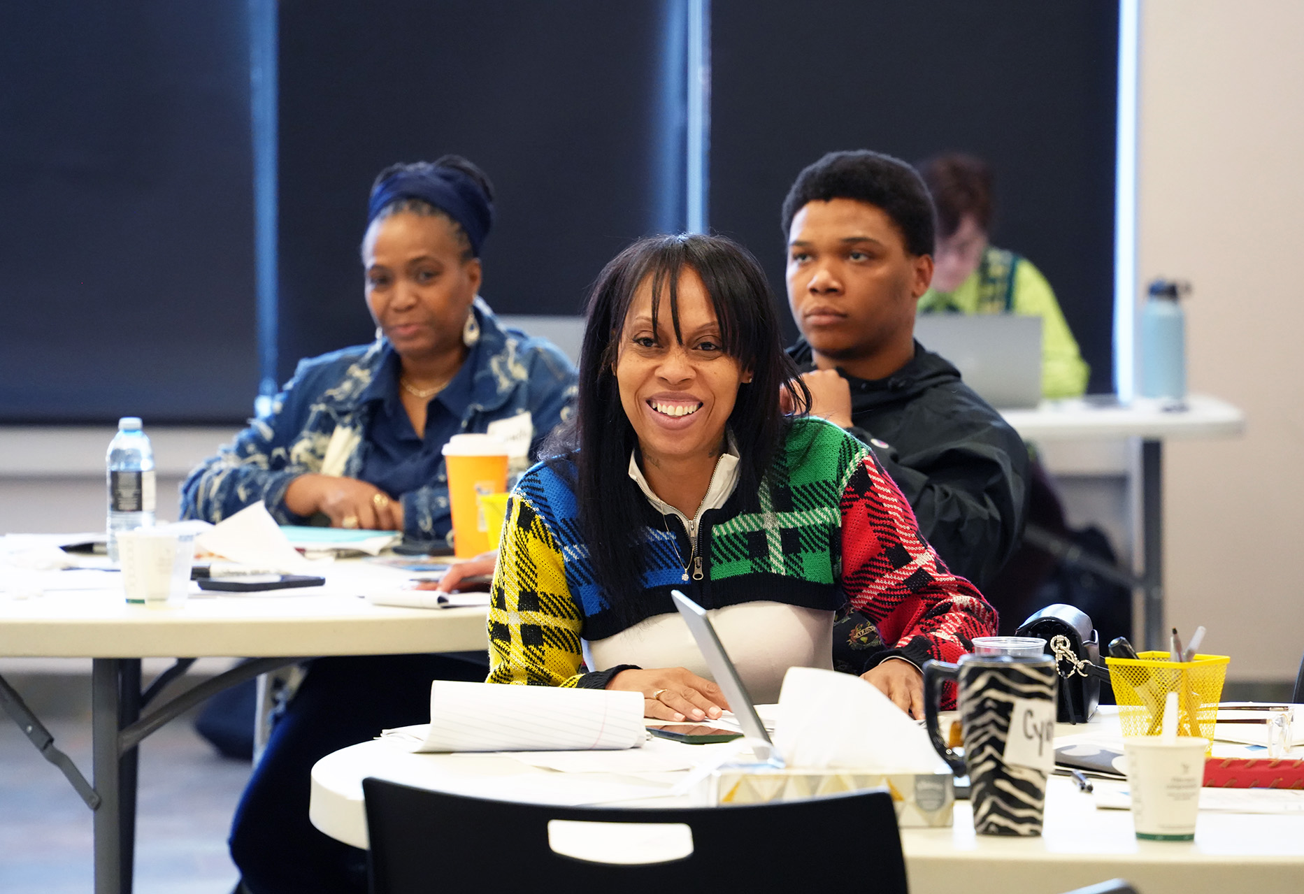 Students at tables listening to instructor.