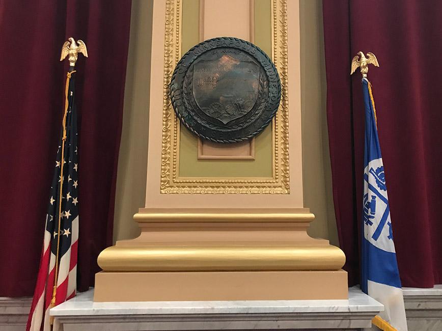 door of Minneapolis City Council chamgers showing city seal and flags