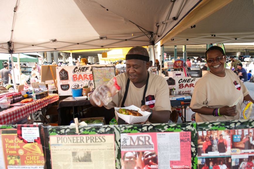 Chef preparing plate of food at the farmers market