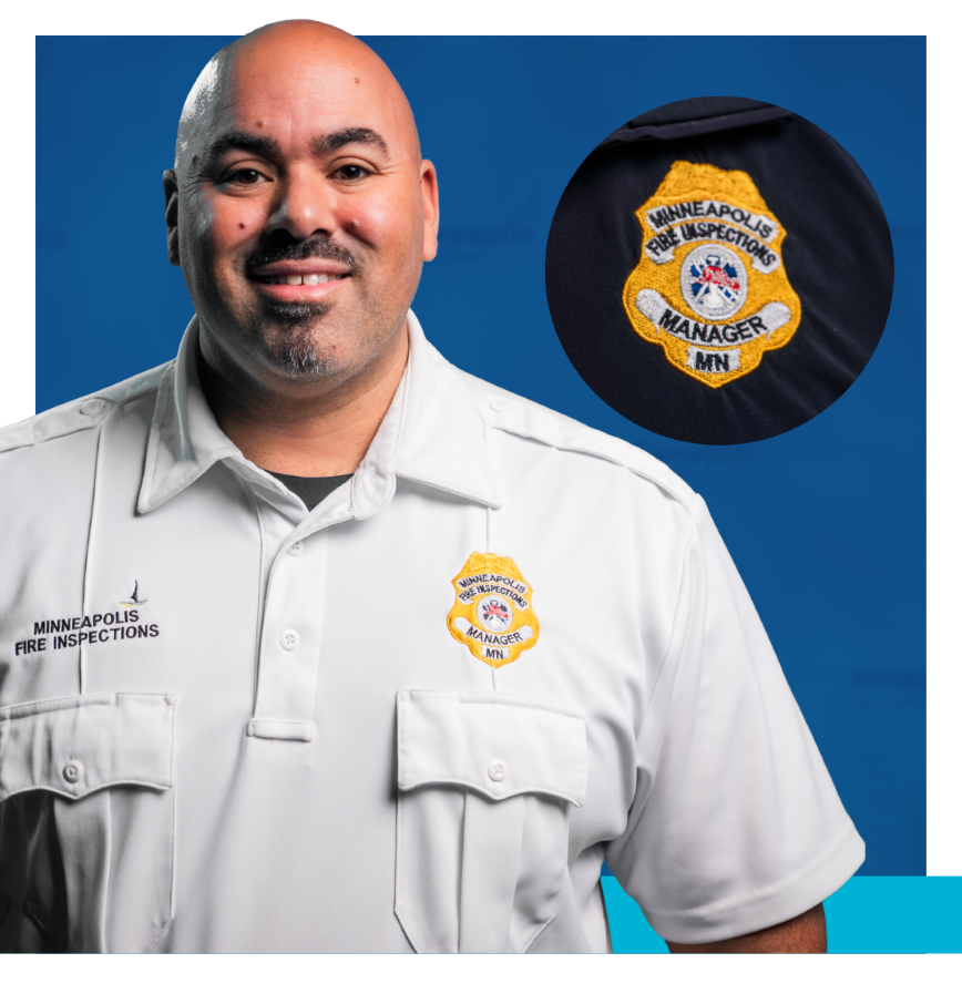 Fire Inspection Manager wearing white shirt and yellow badge that says Minneapolis Fire Inspections Manager MN