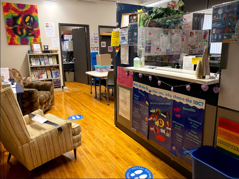 Colorful school office reception area with comfortable chairs, posters, reception desk Colorful school office reception area with comfortable chairs, posters, reception desk
