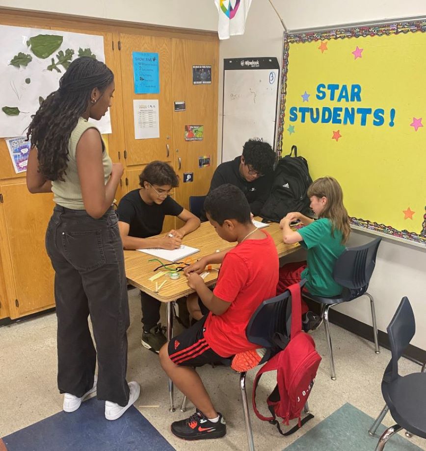 Students sitting at a desk in a classroom. Students sitting at a desk in a classroom.