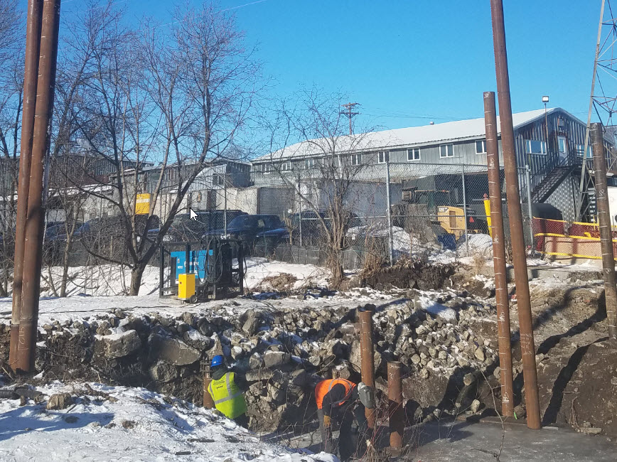 Large pipes sticking out of ground in Bassett Creek 