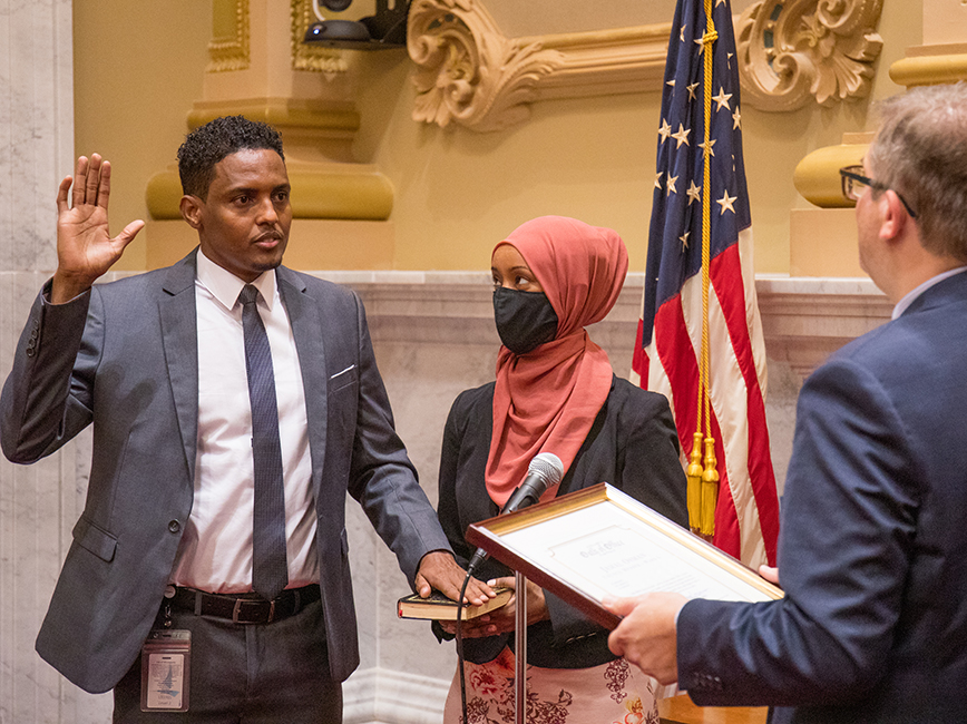 Council Member Jamal Osman takes his oath of office with his wife by his side.