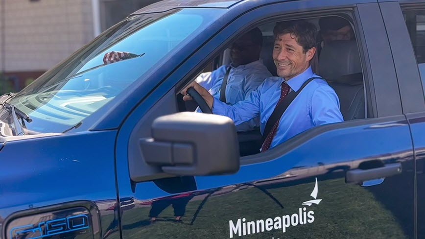 Mayor Frey sitting in a City electronic vehicle.