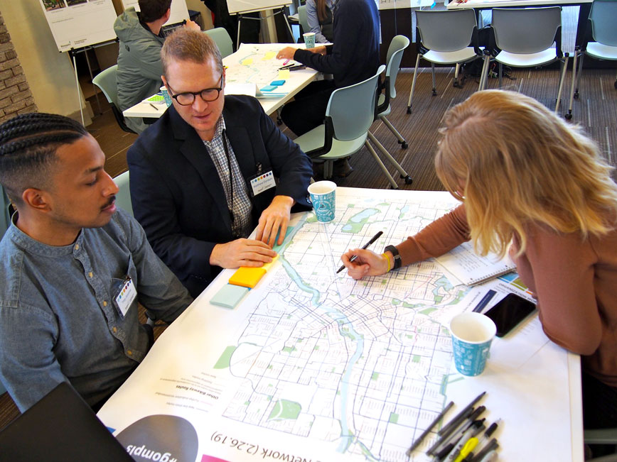 People at community meetings add comments to maps People at community meetings add comments to maps