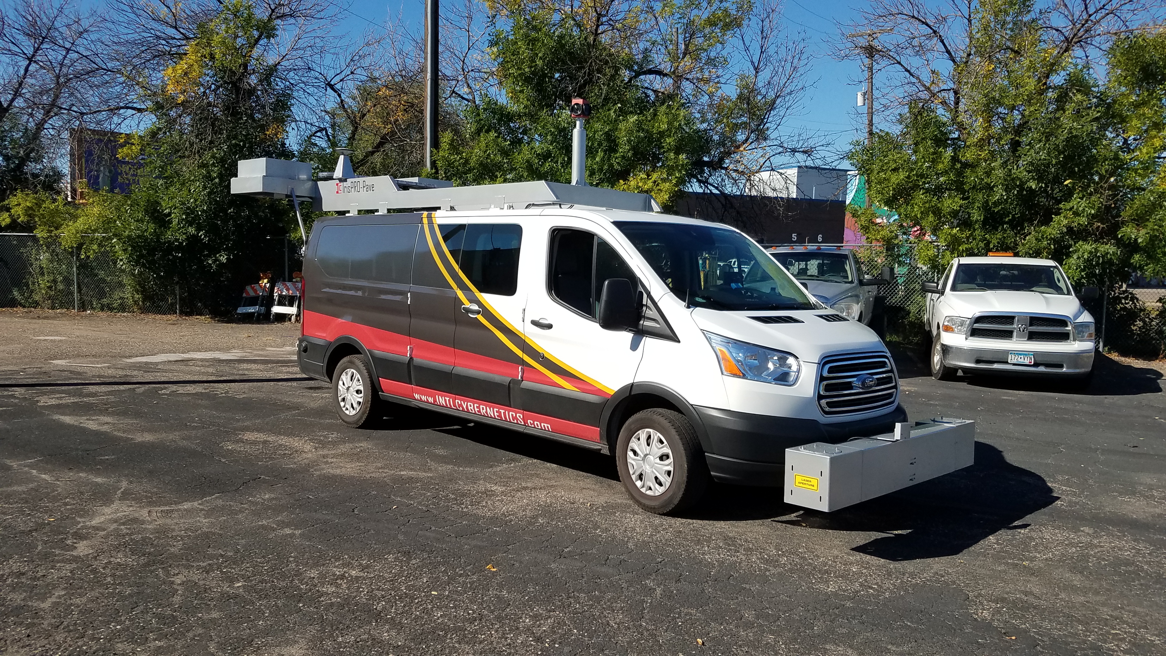 Van with equipment on front and top driving along a city street Van with equipment on front and top driving along a city street