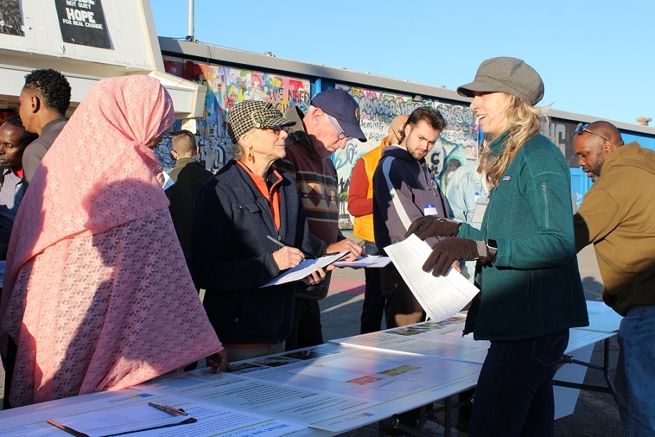 People gathering around a table of displays