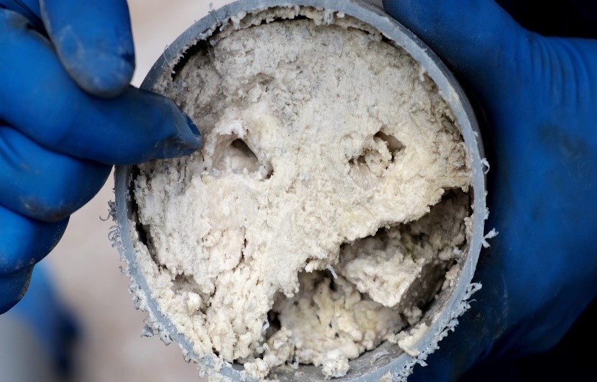 A mass of fats, oils and grease clogging a pipe.