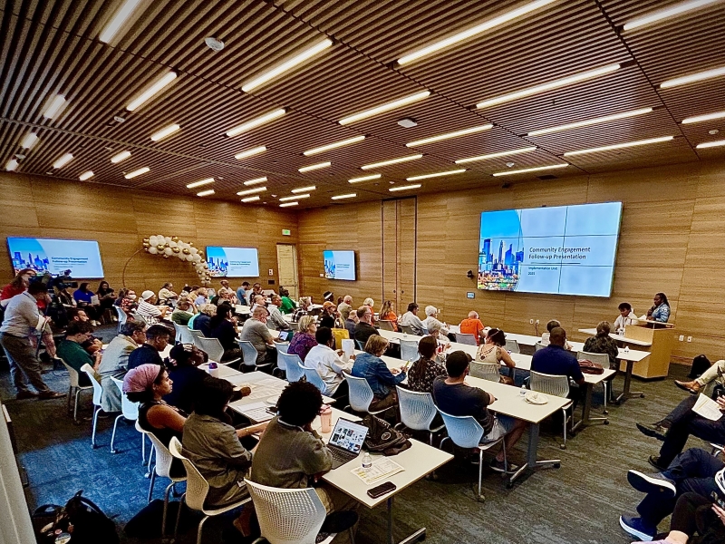 A conference room with people attending a meeting.