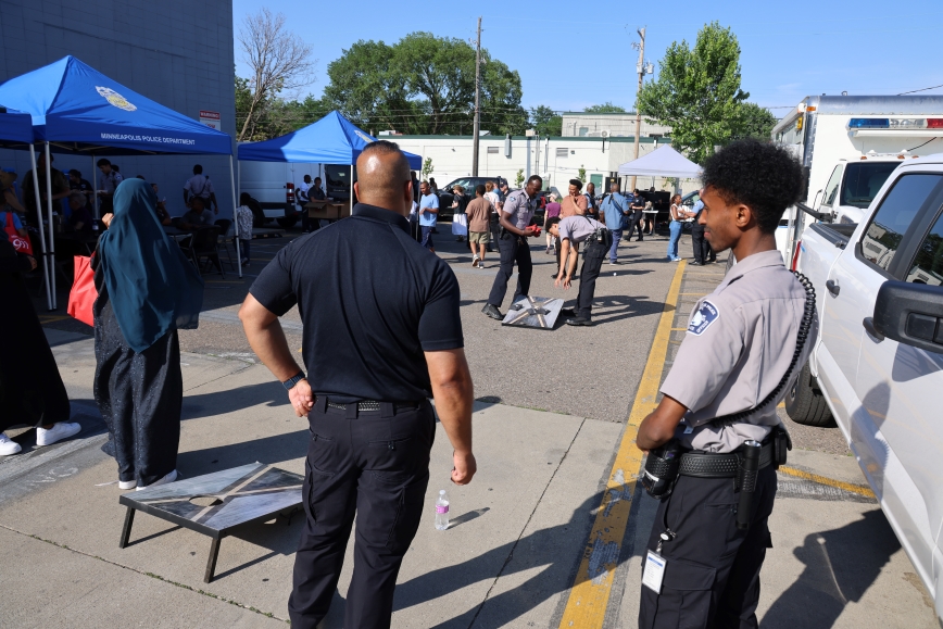 Group of people playing outdoor game at police event