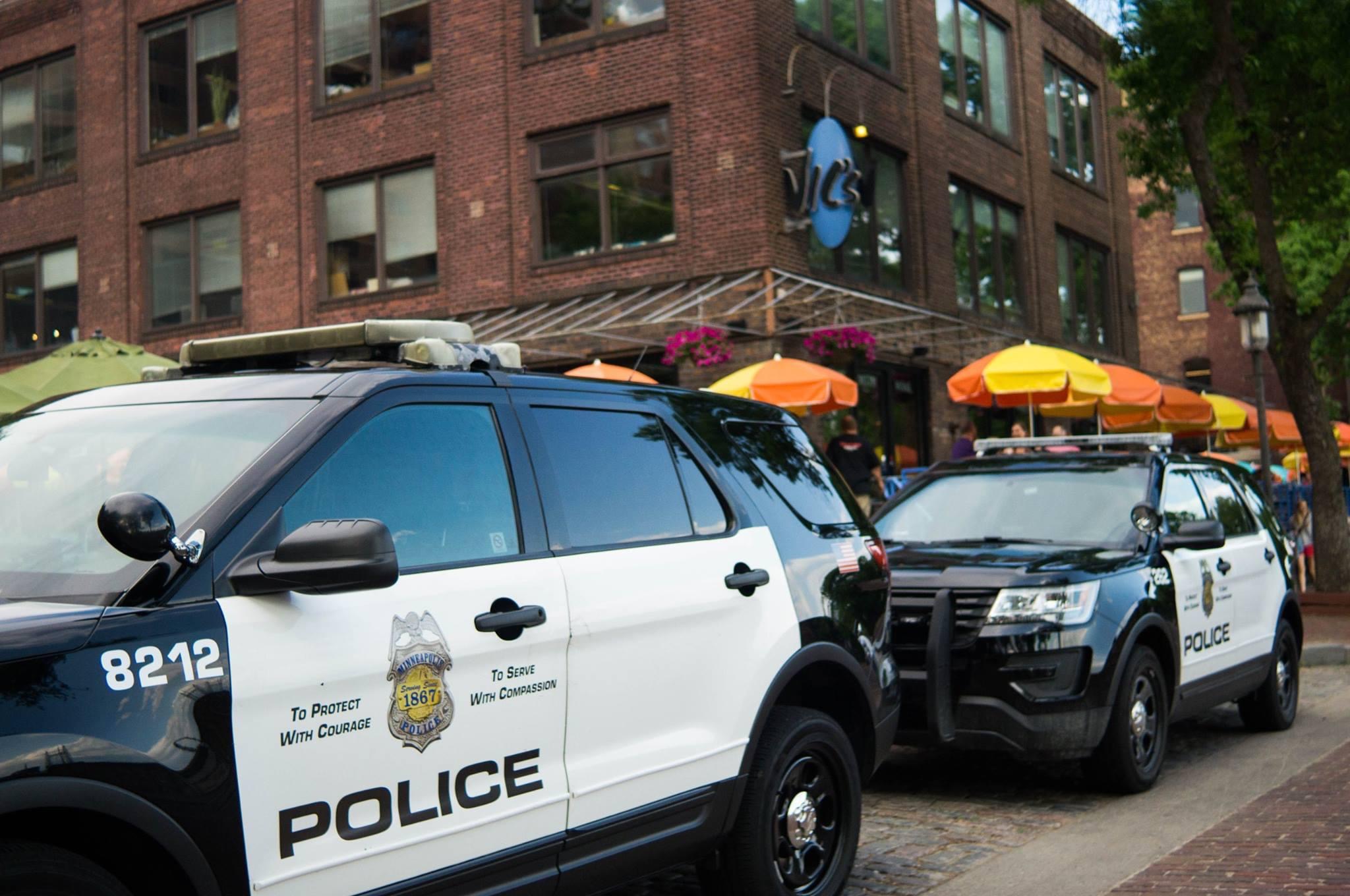 Side of police car showing Minneapolis Police Department seal.