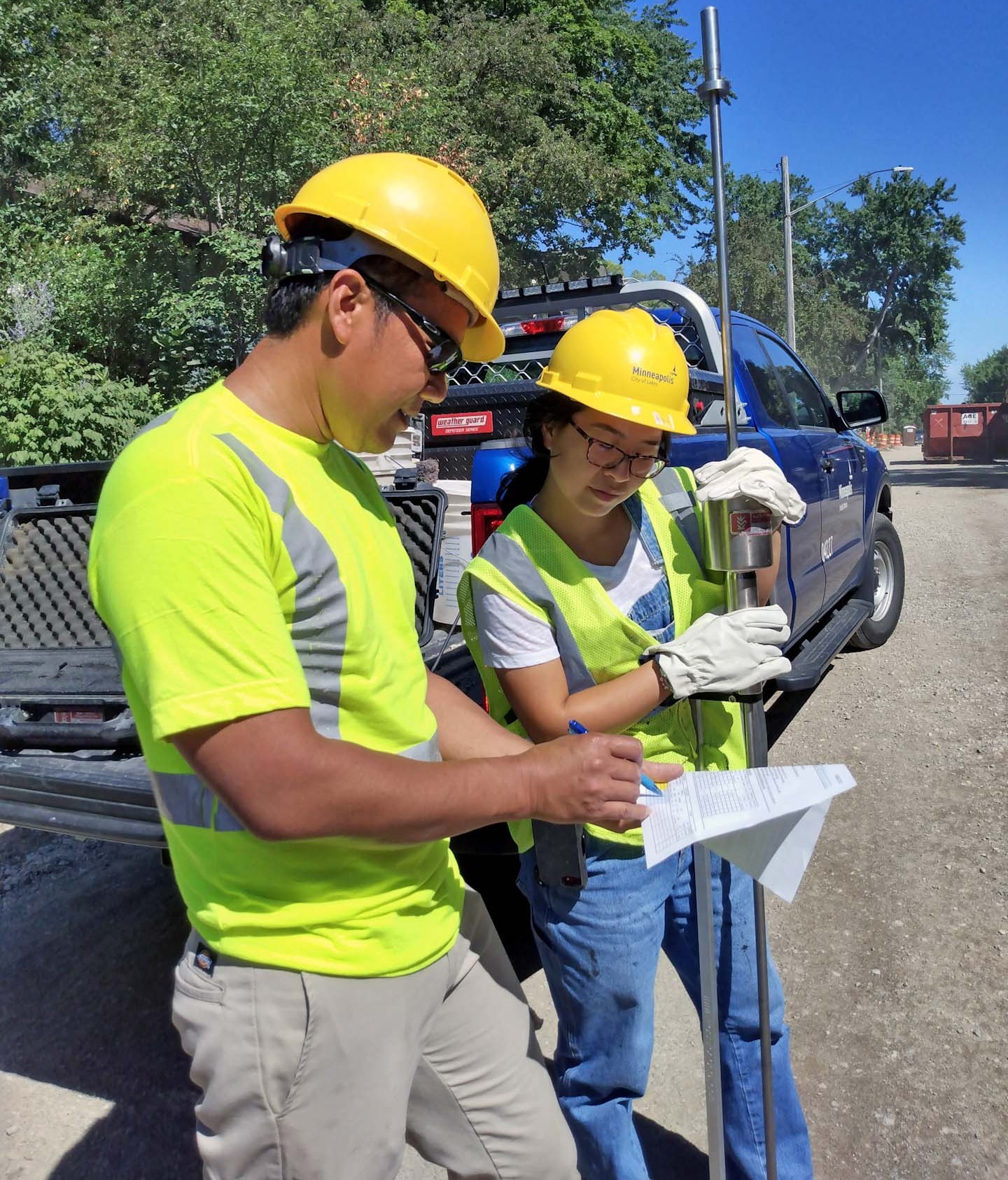 Two Minneapolis Public Works employees by truck