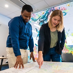 two people looking at map two people looking at map