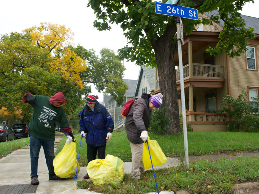 people picking up litter with litter grabbers, gloves and yellow litter bags