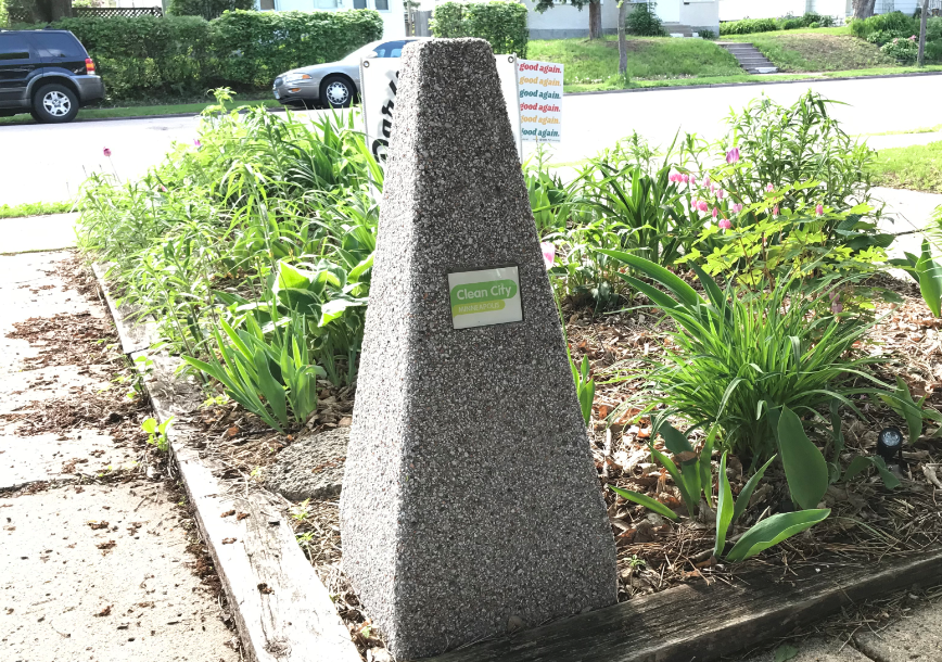 An ash receptacle with a Clean City label on it