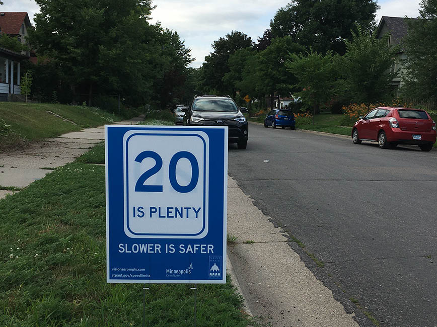 A yard sign that reads twenty is plenty, slower is safer A yard sign that reads twenty is plenty, slower is safer