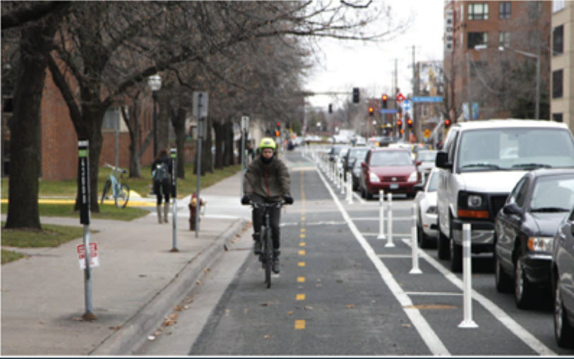 Biker riding along on a two-way protected bike trail