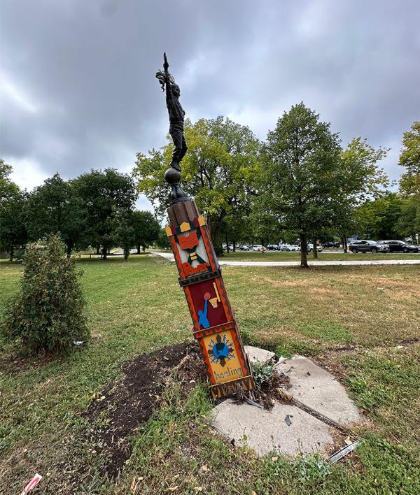 Harrison art sculpture leaning left with broken base.