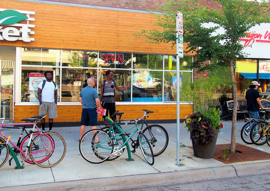 people standing around bikes