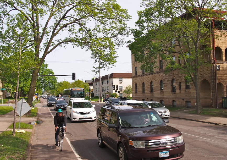 A person on bicycle riding in bike lane A person on bicycle riding in bike lane
