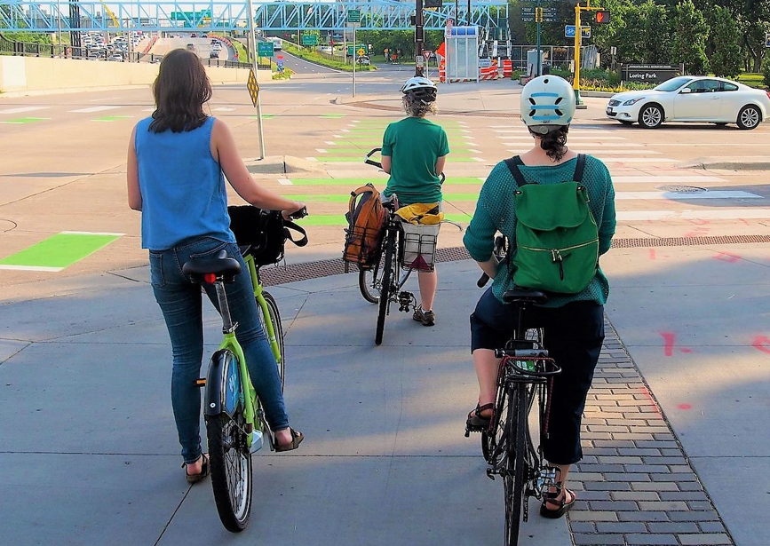 Three bicyclists waiting at red light Three bicyclists waiting at red light