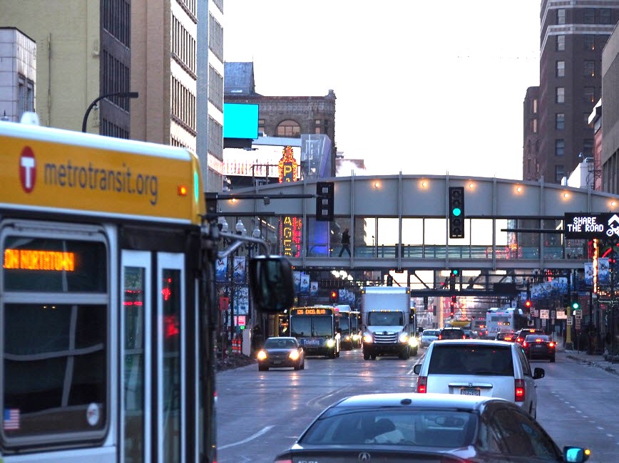 Picture of cars and buses driving on Hennepin Avenue. 