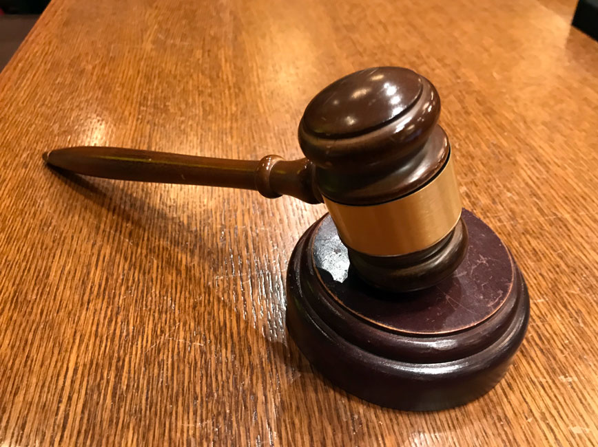 Gavel resting on a wooden table