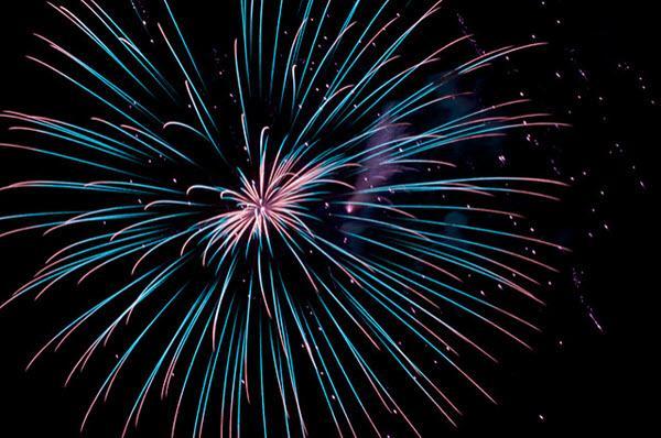 Blue and pink fireworks in the night sky