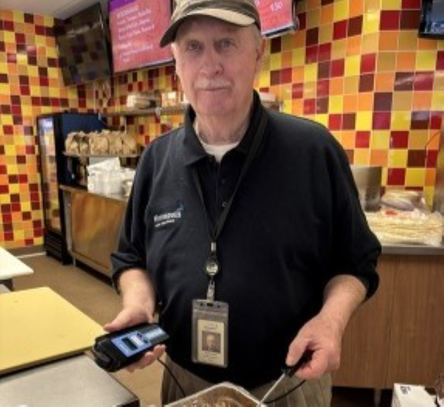 Person measuring temperature of food