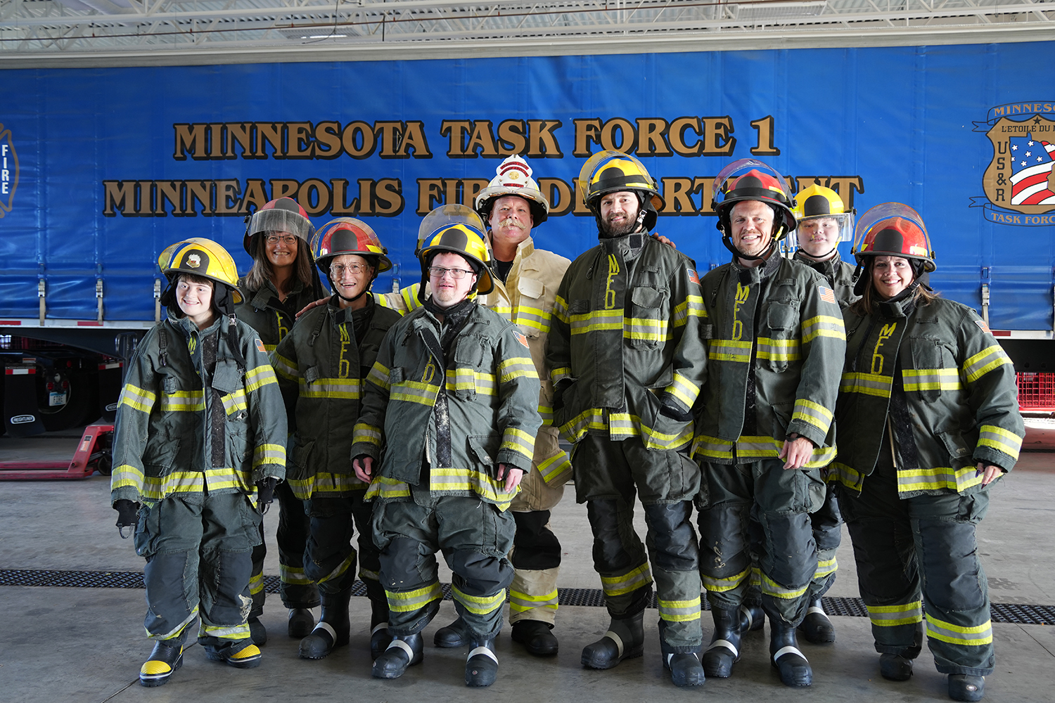 A group of community members dressed in Minneapolis firefighter gear. A group of community members dressed in Minneapolis firefighter gear.