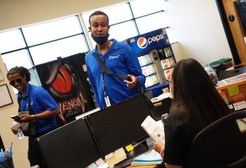 A Community Safety Ambassador visits with a local business. A Community Safety Ambassador visits with a local business.