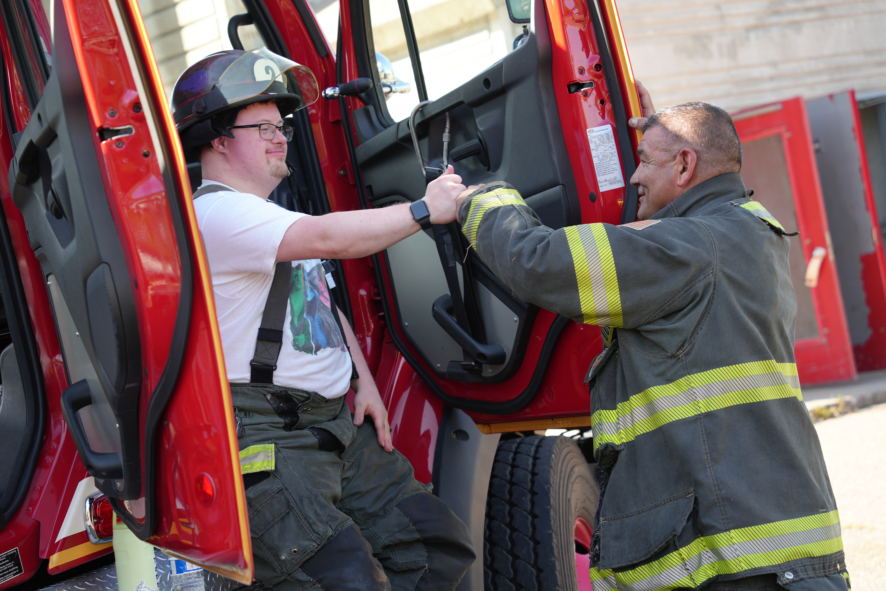 A community member fist bumps a Minneapolis firefighter.