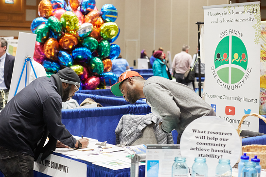 Community Connections Conference exhibit table with balloons