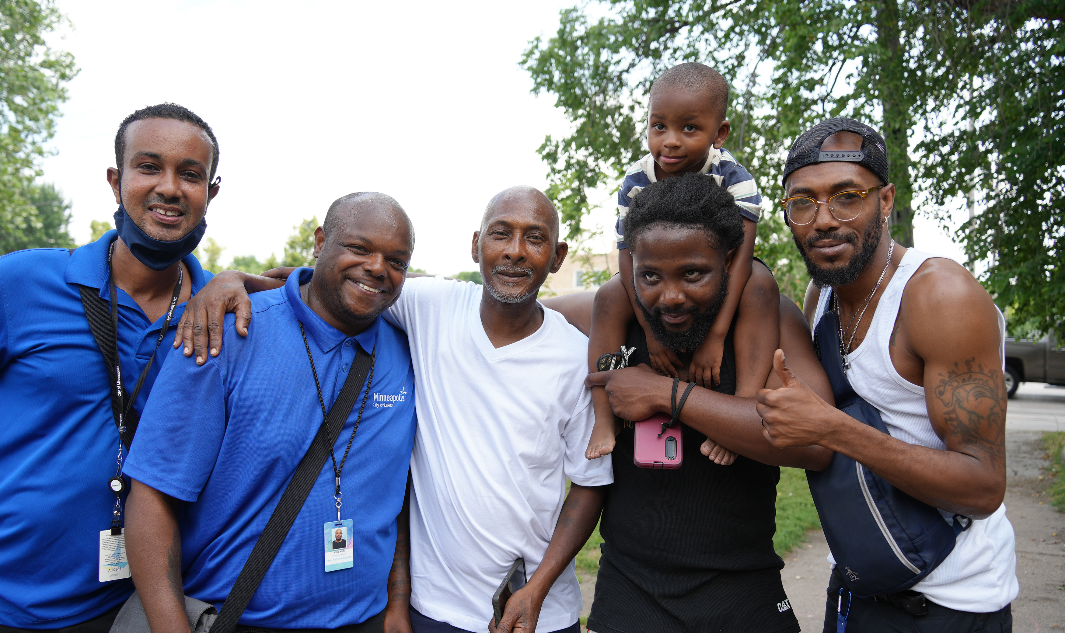 Community safety ambassadors pose with members of the community. 