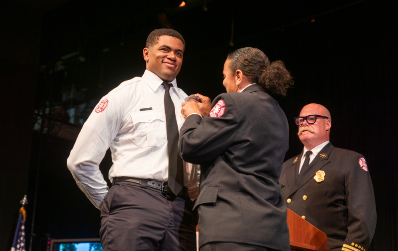 A firefighter graduates from the Minneapolis Fire Academy