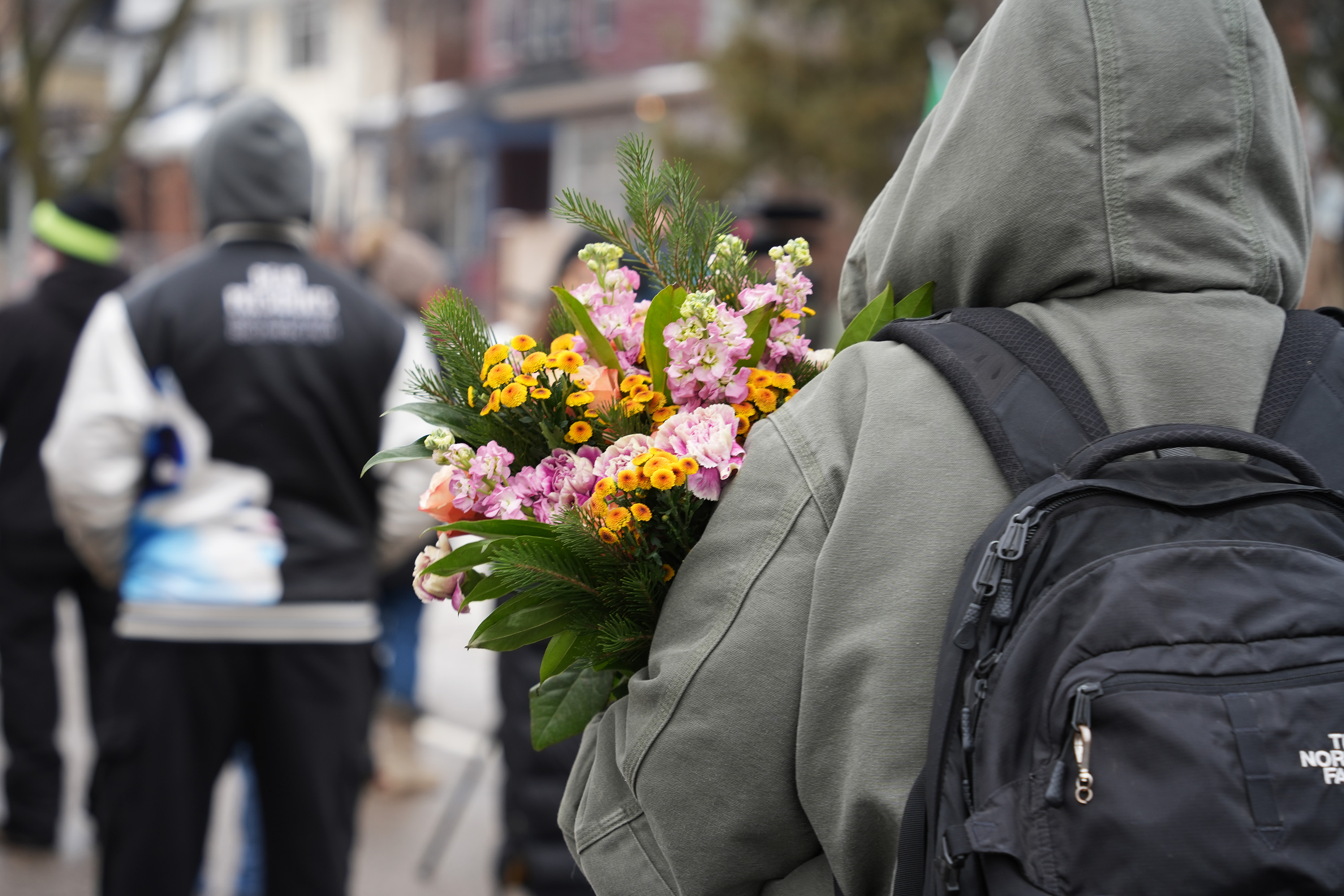 A community member carrying flowers