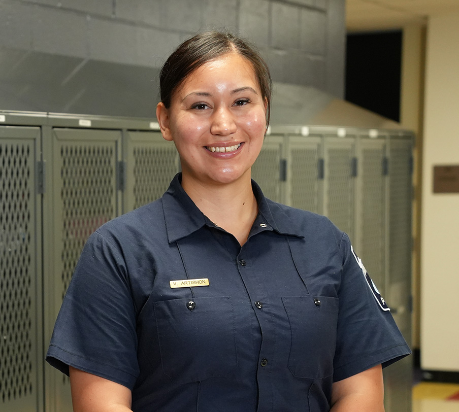 A Minneapolis Police recruit officer standing and smiling.