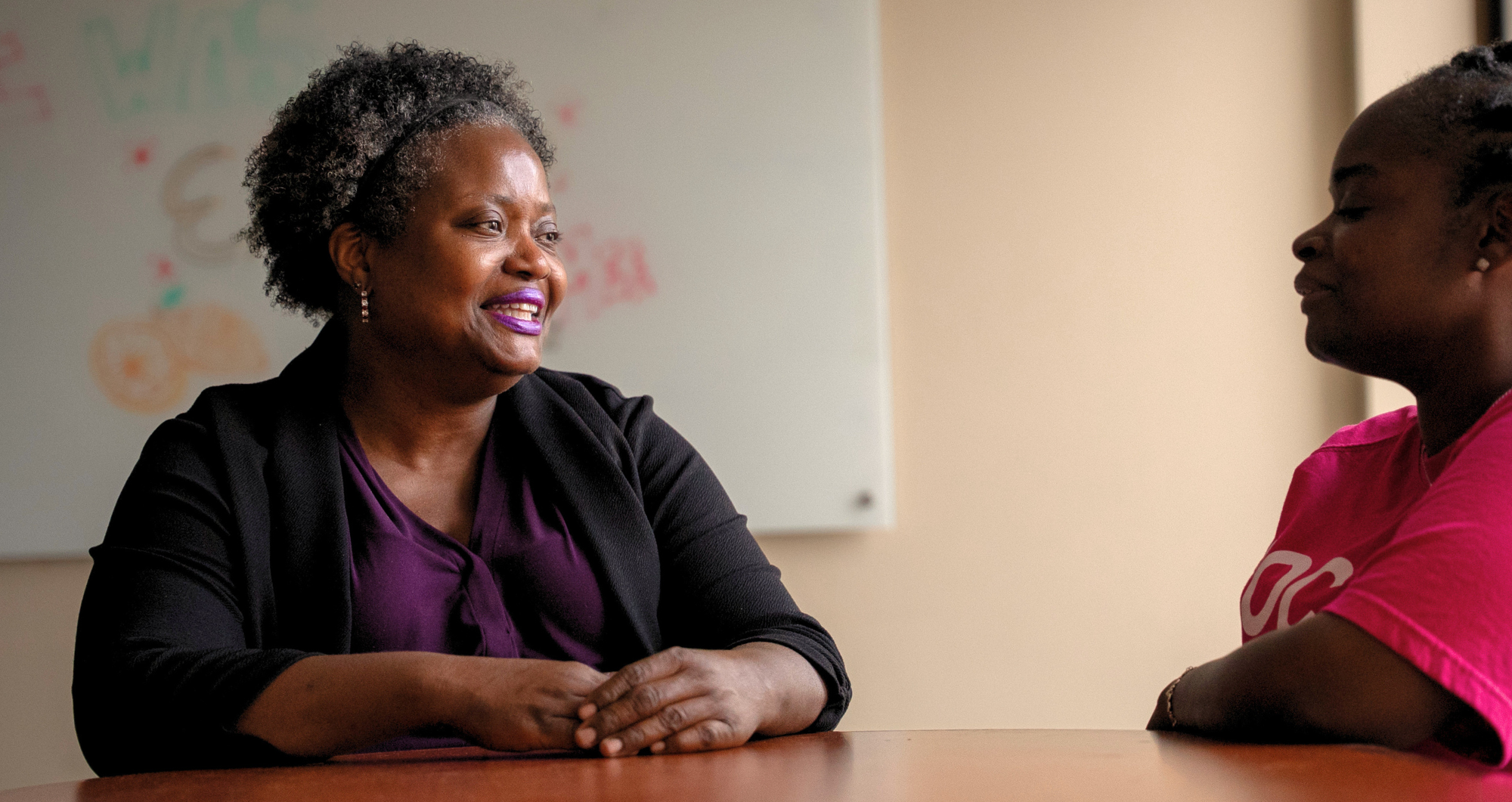 Mildred Saulter and community outreach supervisor sitting across a table