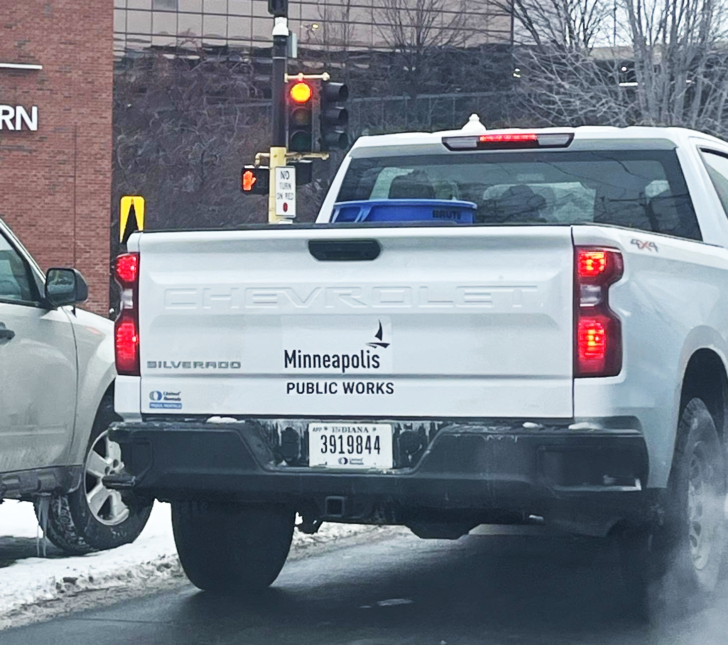 A white truck with a Minneapolis Public Works logo on bumper area
