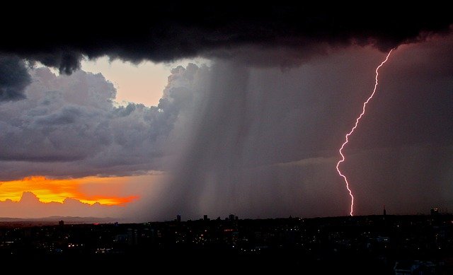Lightening bolt and clouds over city