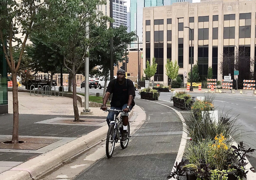 Person riding bike wearing hat