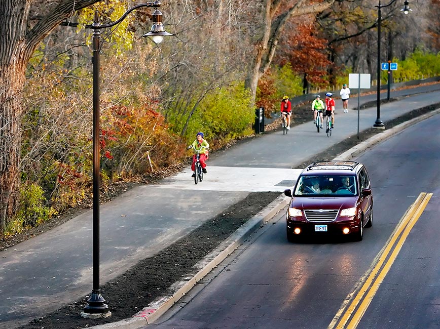 Bicyclists and driver on newly paved streets