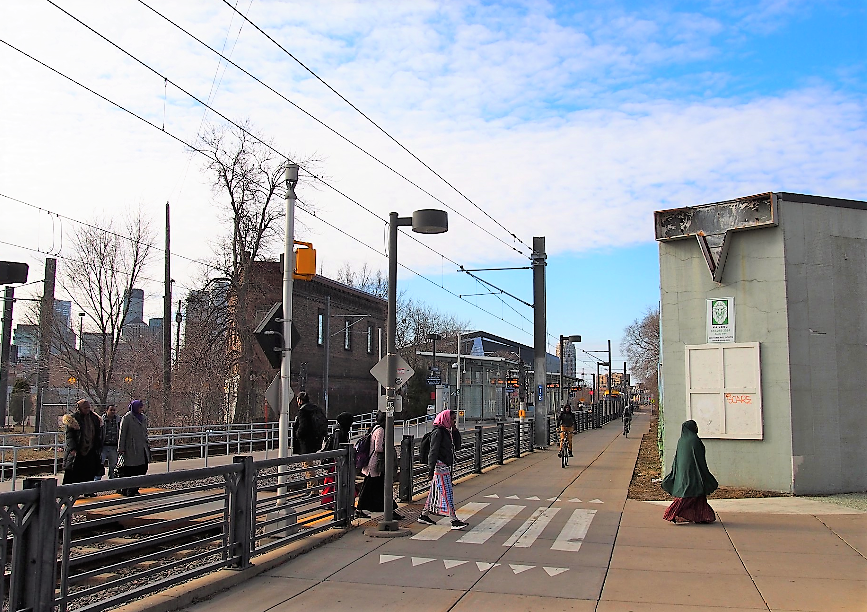 Pedestrians and bicyclists on a light rail station