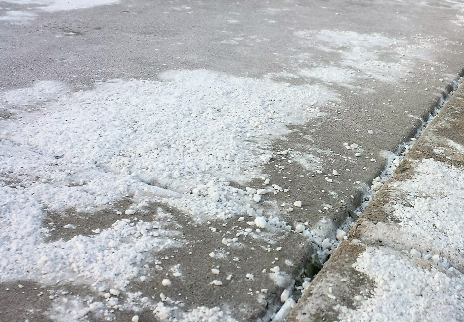 Pile of rock salt on sidewalk Pile of rock salt on sidewalk